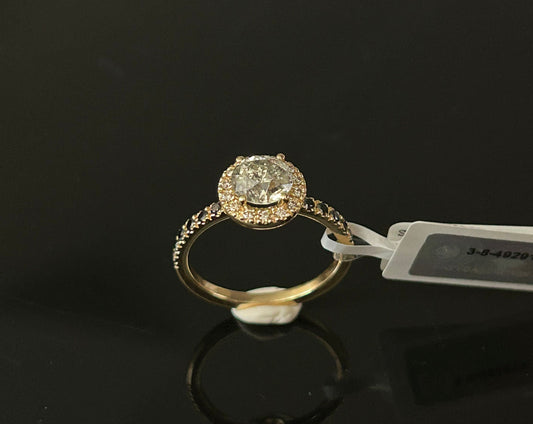 Gold ring with a diamond on a black background